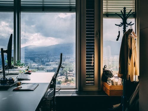 A home office setup in front of a window