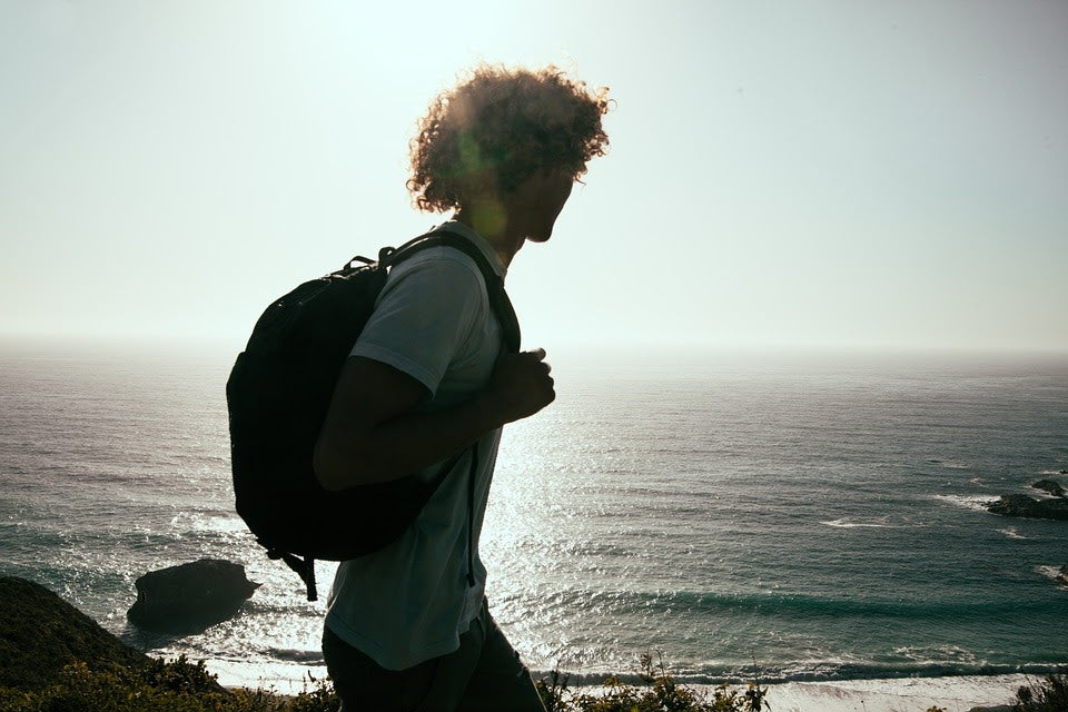 Man hiking and wearing a backpack