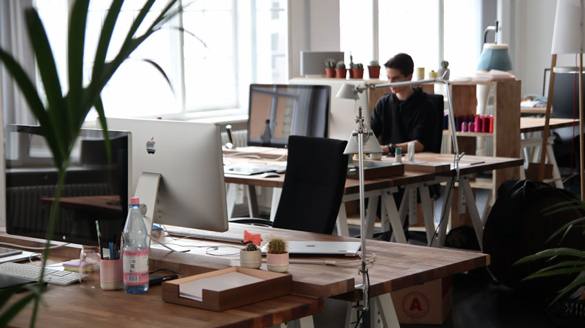 Man Sitting at Desk in Contemporary Workplace