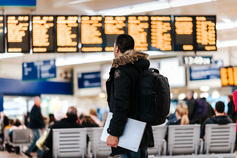 man with backpack at airport