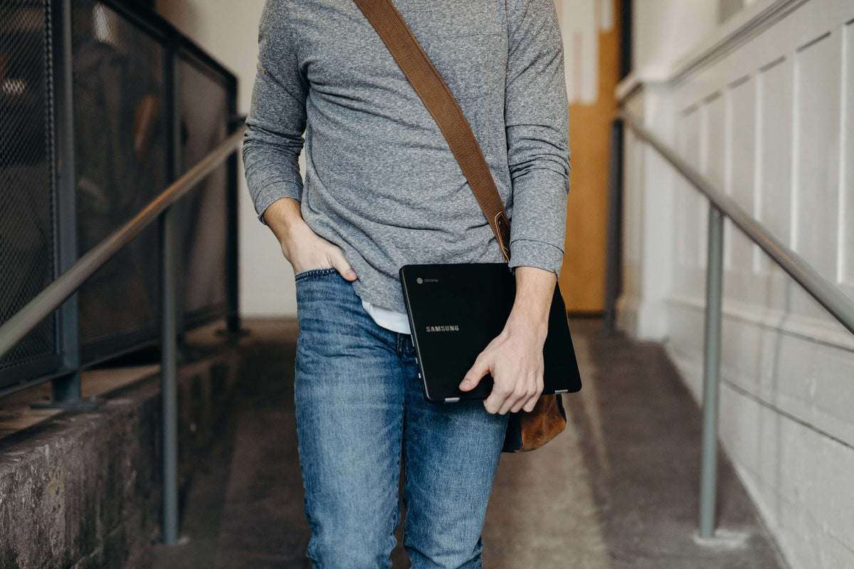 Person Carrying Laptop While Walking