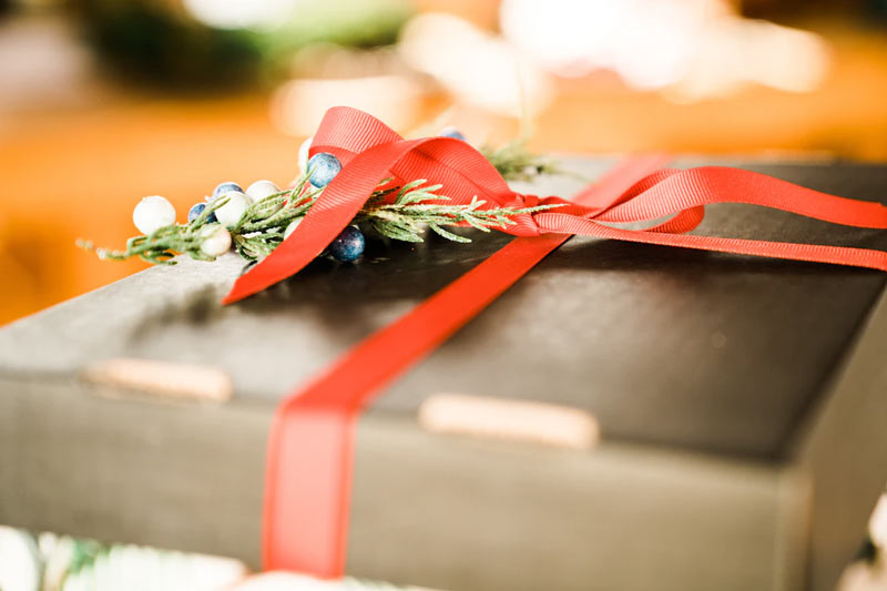 A slim box with holiday gift wrapping.