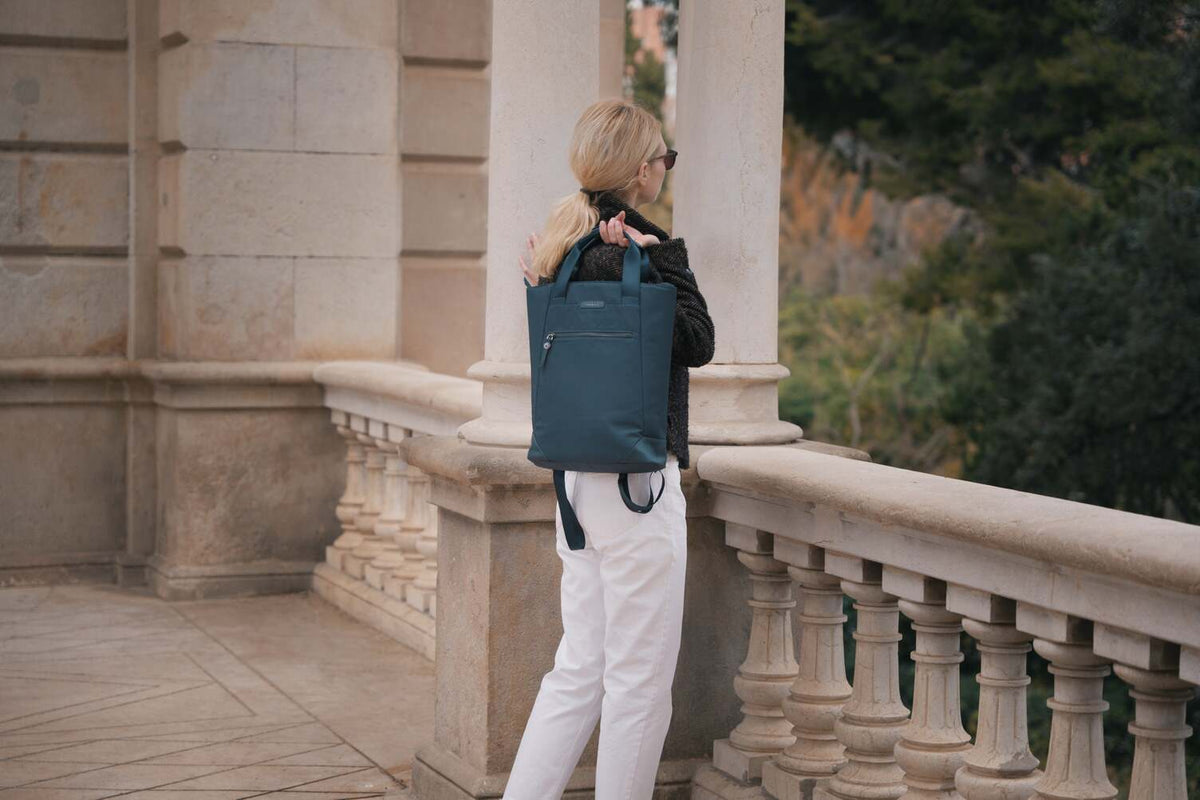 woman with laptop bag outside