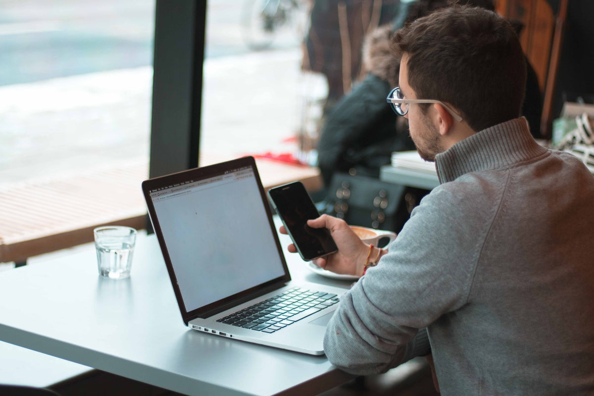 Young professional man with laptop in public