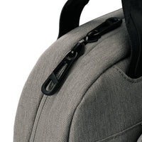 Close-up of a gray textured fabric bag with a black zipper pull and black strap on a white background.