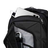 Black backpack with electronic devices inside on a white background