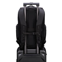 Black backpack with trolley strap on a suitcase on a white background
