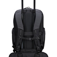 Black backpack with visible trolley straps on a white background