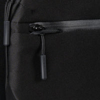 Close-up of a black backpack with a zipper and brand logo.