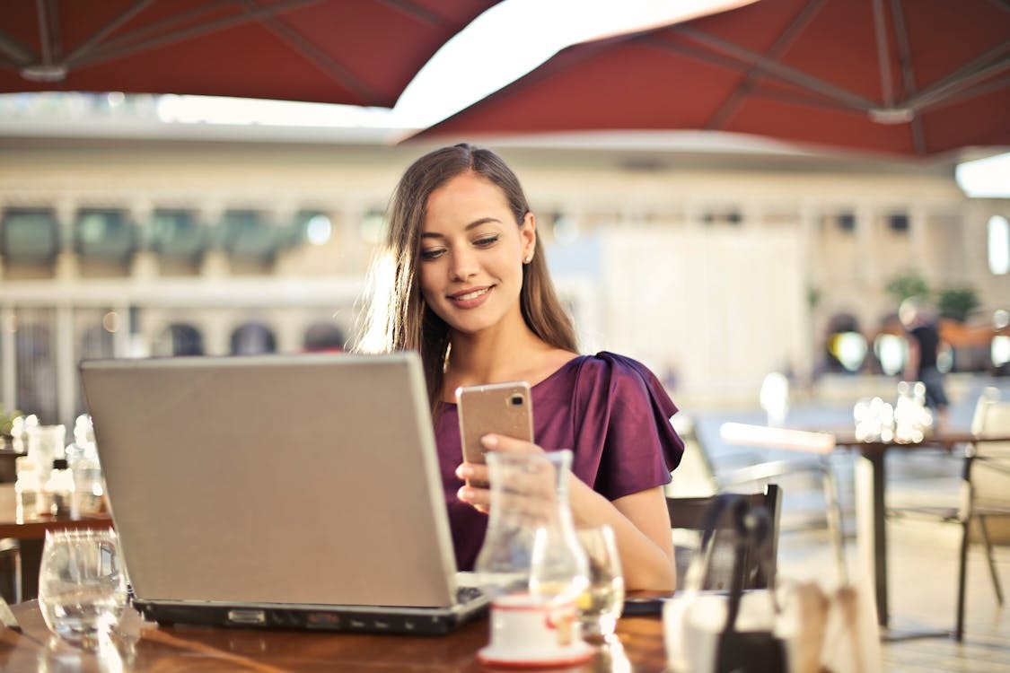 A person researching the best laptop backpacks for travel sitting outside