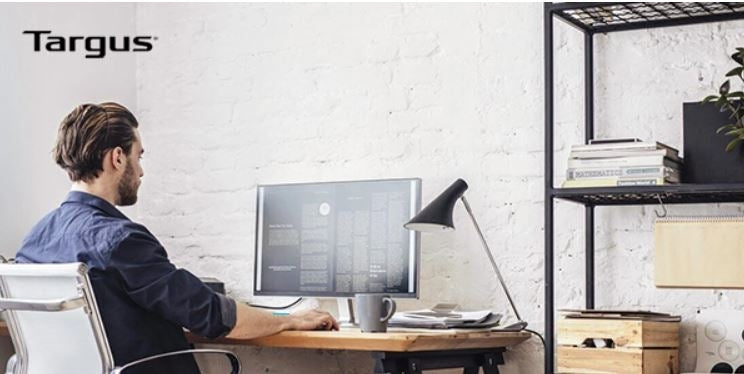 A person working using a home office computer setup