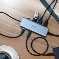 Targus USB hub with multiple cables on a wooden surface