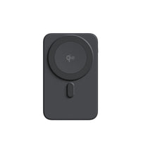 A dark gray MagSafe-compatible wireless charging case or adapter with a circular magnetic ring and a small vertical button, shown on a plain white background.