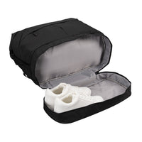 A black shoe bag shown open, with a pair of white sneakers inside, on a plain white background.