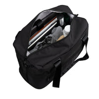 A black nylon duffel bag shown open, revealing its interior storage capacity filled with travel items such as a laptop, shoes, and toiletry bottles, on a solid white background.