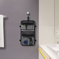 Targus black laptop backpack inside accessory compartment lifestyle on bathroom wall