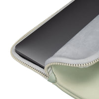 Green zippered pouch with a black electronic device inside on a white background