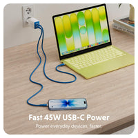 A blue USB-C cable shown plugged into a wall outlet, connected to a yellow laptop and a smartphone on a light wood desk. Text at the bottom reads 'Fast 45W USB-C Power Power everyday devices, faster.