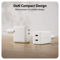 Two compact white GaN chargers with USB-C ports are shown on a wooden surface against a soft light gray background. Text at the top reads 'GaN Compact Design' and 'More power in a smaller design.