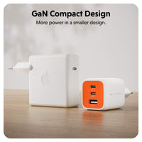 Two compact wall chargers on a wooden surface against a light background. The larger charger on the left is white with an Apple logo, and the smaller charger on the right is white with an orange front panel and visible HYPEREN branding.